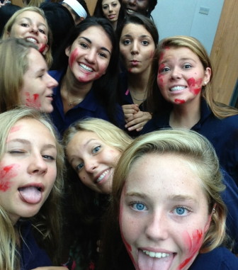 The quintessential first day of school selfie, with silly expressions and the seniors' red paint on our faces. Credit: Allie Primak