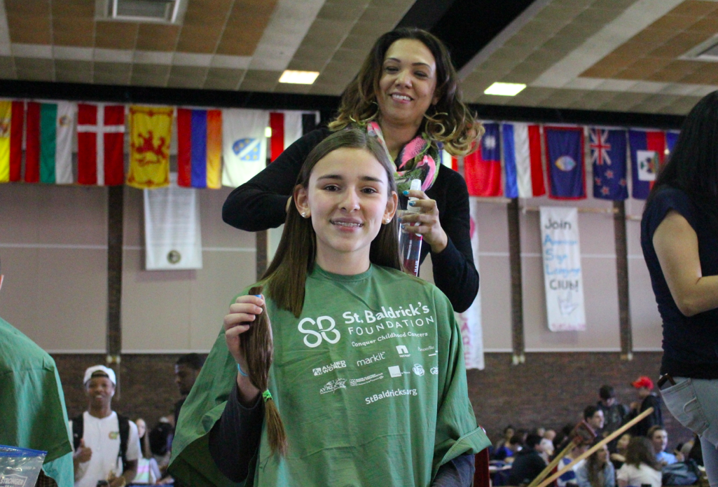 Ms. Vittoria, who advocates increased communication between Student Government and the student body, may be seen here cutting her hair as part of GHS' St. Baldrick's fundraiser. Credit: Leslie Yager.