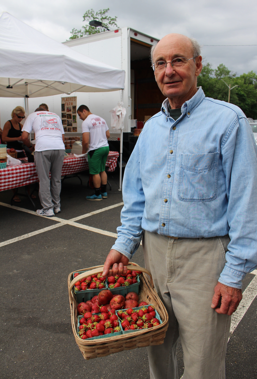 Jim Carr, the market director for Greenwich Farmers Market, makes sure that all the farmers are delivering produce grown locally. That includes the lilies, "Gerbers" and roses grown by Roses for Autism in Guilford, CT. And that explains why these flowers last so long in vases. Credit: Leslie Yager