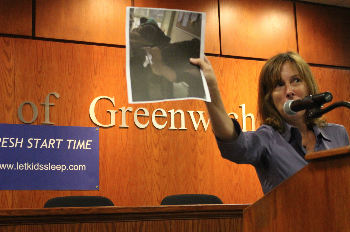 Valerie Erde holds up a photo of GHS students asleep on their desks during class