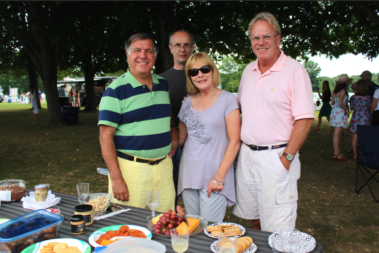Dean Damanos, Clive and Michele Milton and Peter Le Beau enjoy an elegant spread at the East Coast Open on Sunday, Aug. 23, 2015.