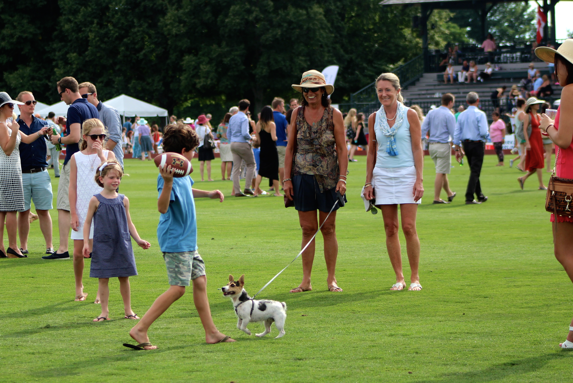 Divot stomping, frisbee and football tossing during intermission at Greenwich Polo Club during Day 1 of East Coast Open. Credit: Leslie Yager