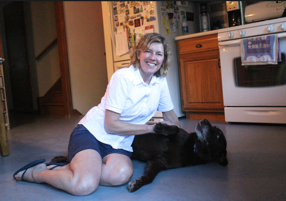 Lauren Rabin at home with Chocolate Lab Tracey in Glenville. Credit: Leslie Yager