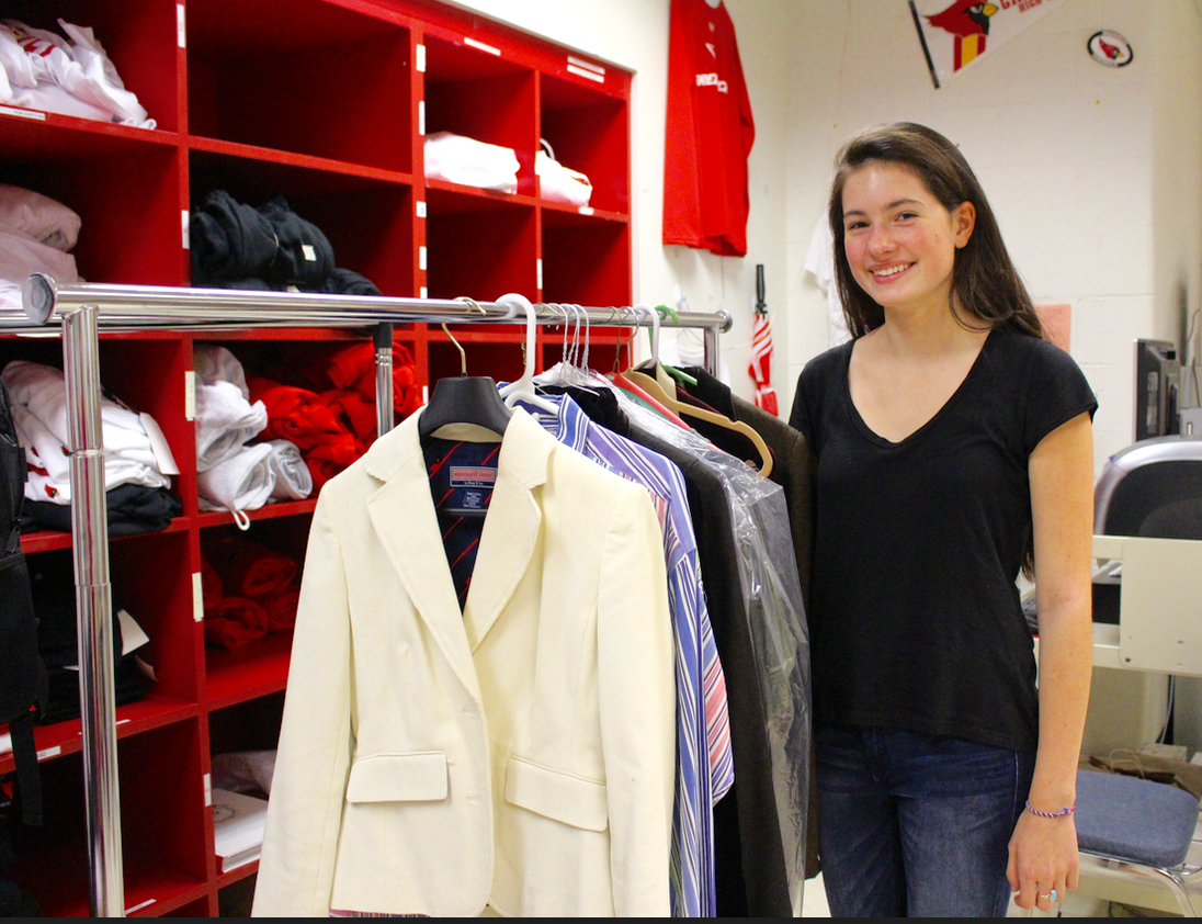 Kate Piotrowski in the student activities offices at GHS. The rack of donated clothing was beginning to take shape. Credit: Leslie Yager