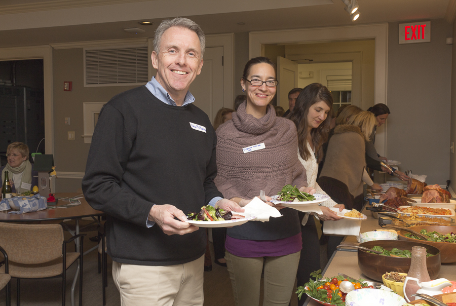 Naill McMorrow and Deanna Novak delight in the potluck tempting food. Credit: Karen Sheer