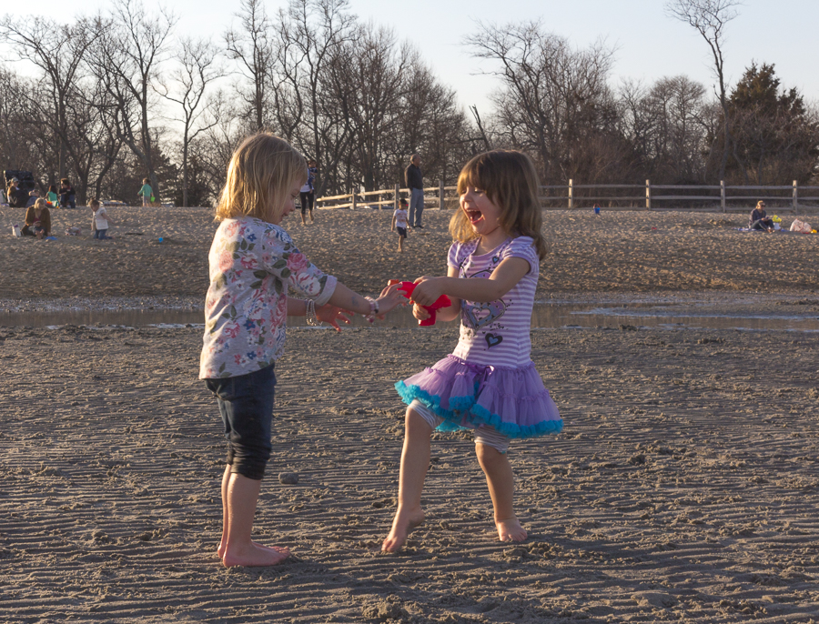 Two adorable barefoot girls play on a beautiful day at the beach. Credit: Karen Sheer