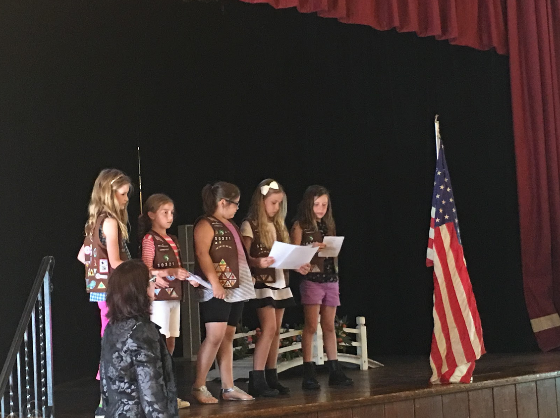 Selected Girl Scouts read the poem “Nobody Told Me.” Credit: Sarah Xu