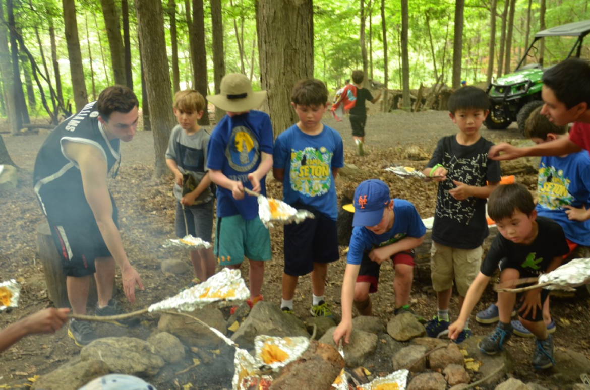1- Cub Scouts prepare nachos on wishbone sticks with foil they made at Camp Seton in Greenwich. Photo Credit: CJ Gaddis 