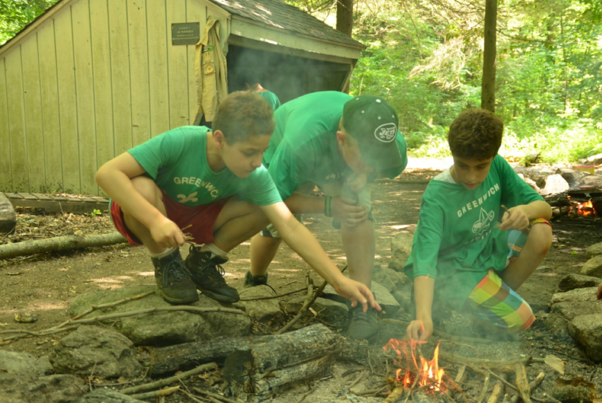 Boy Scouts Ben Levine, James Donovan and Brandon Ramos, man the cooking fire at Camp Seton in Greenwich. Photo credit: CJ Gaddis