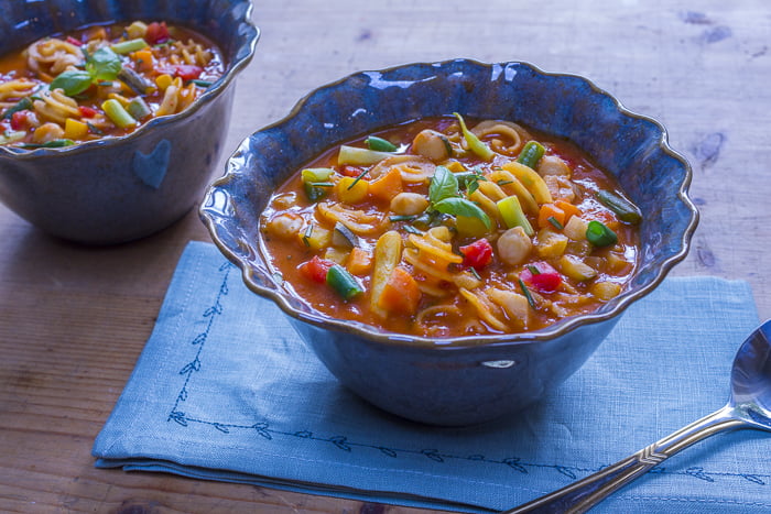 Serve up portions of Minestrone in handmade bowls and float a drizzle of olive oil and fresh herbs on top. Credit: Karen Sheer
