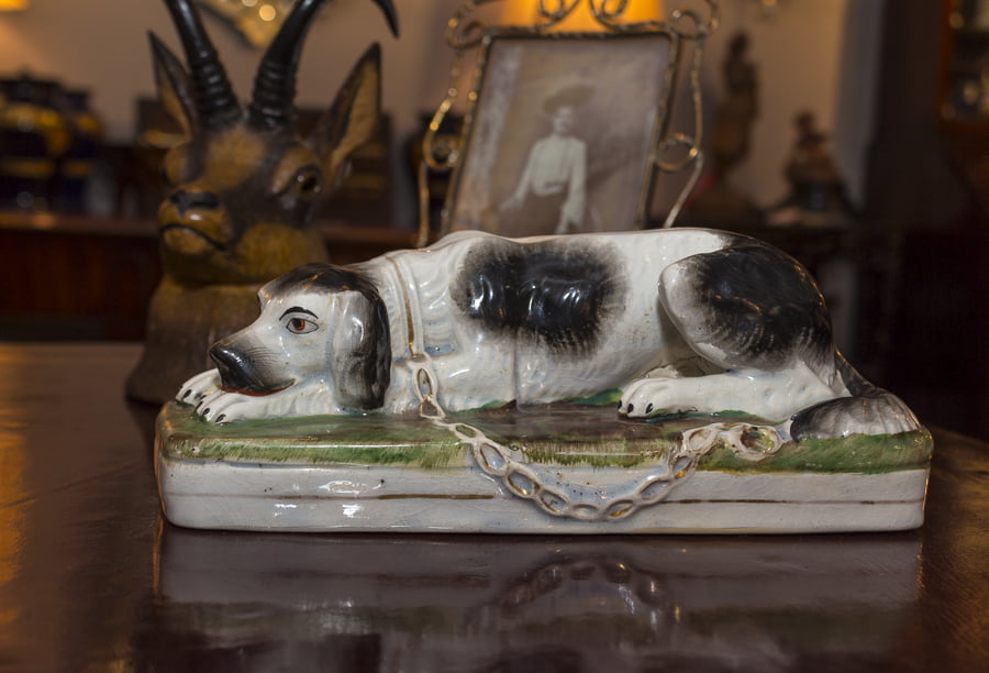 An irresistible Staffordshire dog sits on a leather table from Zane Moss Antiques. Credit: Karen Sheer