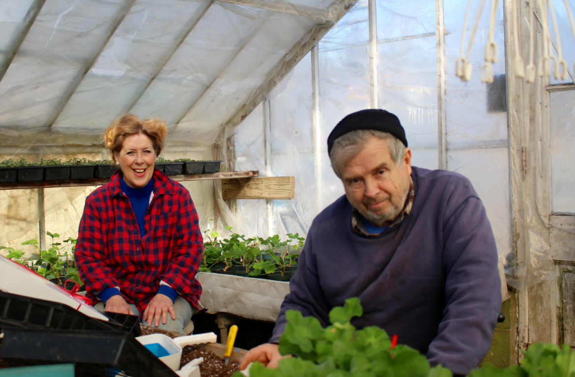 Farmer John and Kathy in the greenhouse at 1332 King Street. Photo: Leslie Yager