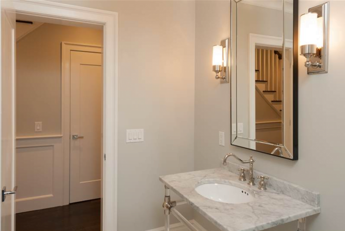 Powder Room: Large 1st Floor Powder Room appointed with Linen Closet and Herringbone Designed Floor