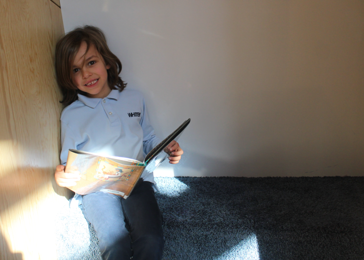 A Whitby student enjoys quiet reading in one of the maker space cubbies. Photo: Leslie Yager