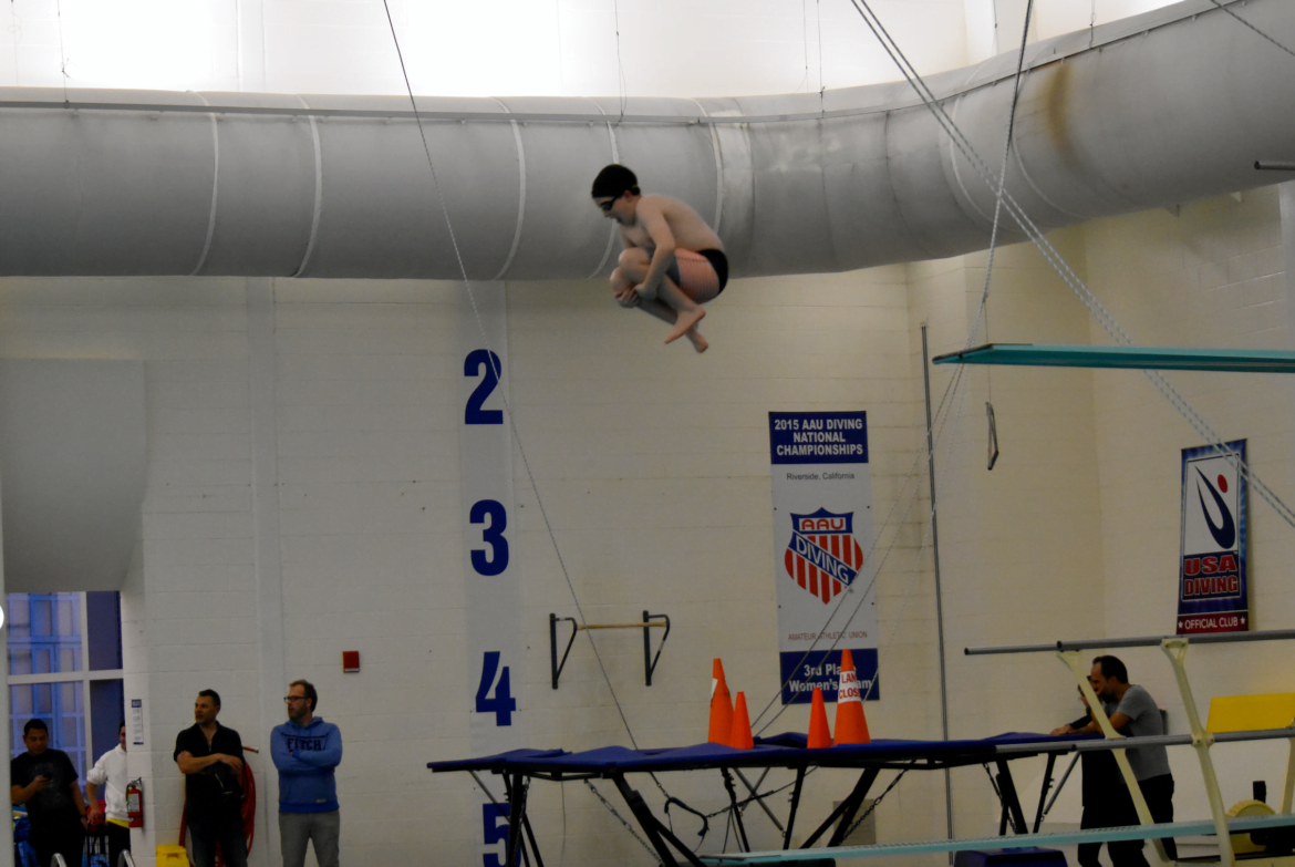  A Boy Scout takes the plunge off the 3-meter platform cannonball style at the YMCA “Scout Night” event in Greenwich. Photo credit: Heather Brown