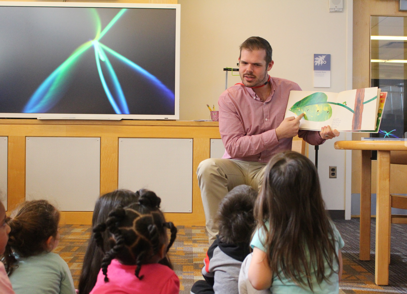 Cody Ludvinsky, a Hamilton Avenue FLES teacher, read to preschoolers on March 2. Photo: Leslie Yager