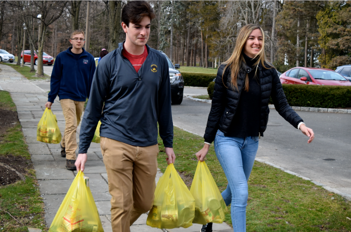 FSYC members Tatiana Liberman and Max Kilberg help transport bags of food items to Neighbor to Neighbor at Greenwich Scouting’s annual “Scouting For Food” drive in Greenwich. Photo Credit: Heather Brown