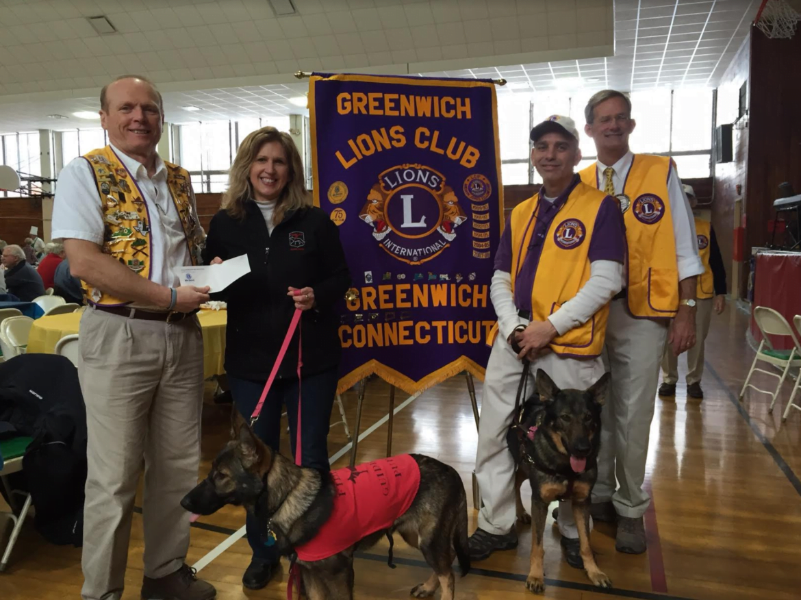 Pictured receiving the check for Fidelco is Kristine Fletcher with, from left, David Bonney, Lions President, Alan Gunzburg, club secretary with his guide dog Kili, Allen O’Farrell, Lions Second Vice District Governor, and Fidelco guide dogs in training.