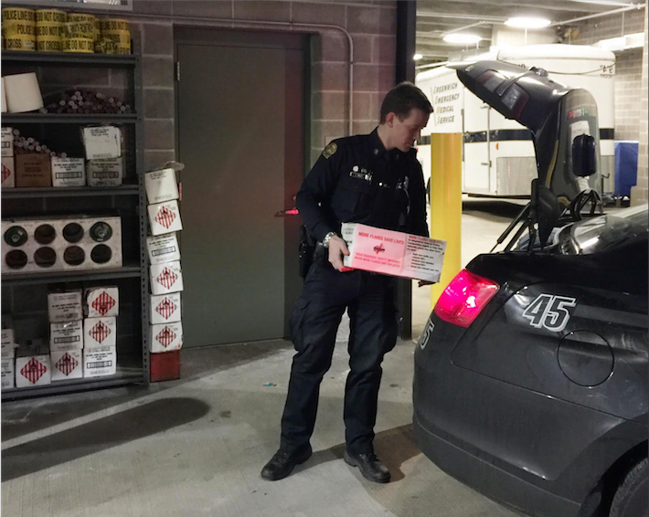  Photo of Officer Luke Kelly loading trunk with additional flares. Photo: GPD