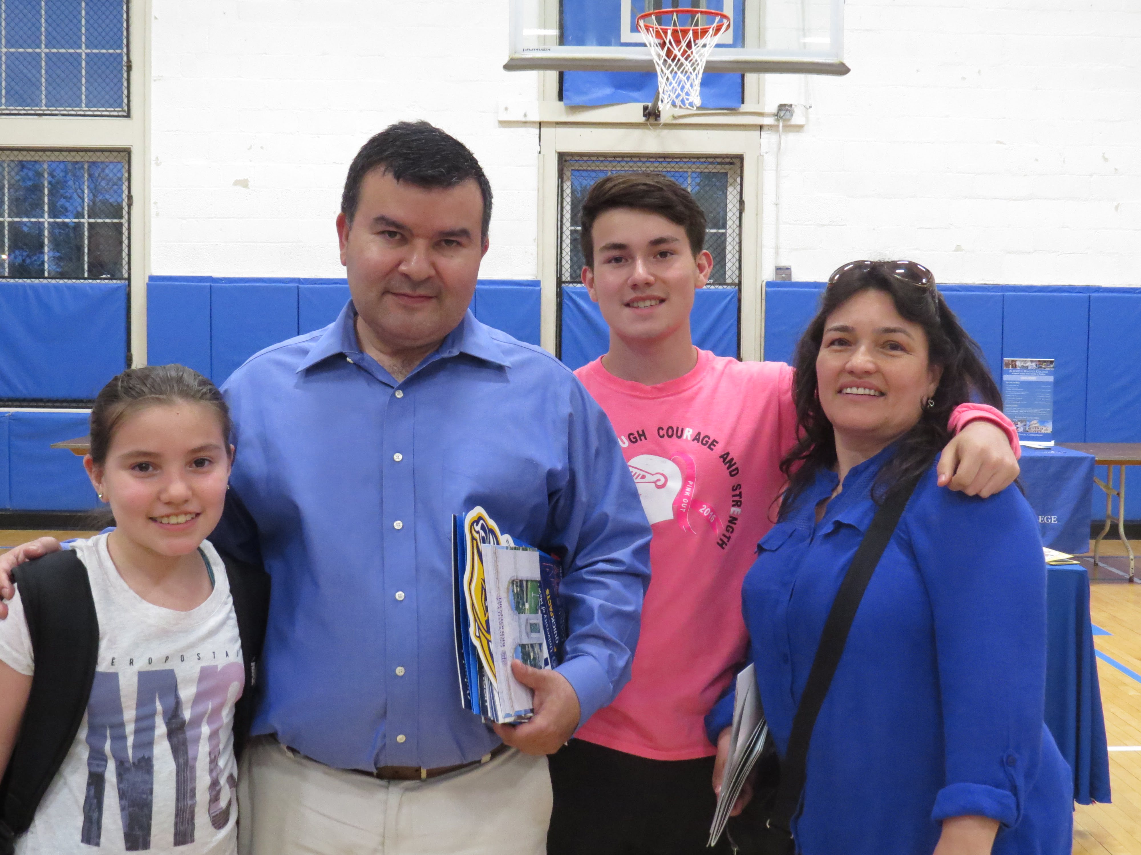 Marvin Campos (center right) and his family attend the BGCG college fair. May 23, 2017. Photo: Devon Bedoya