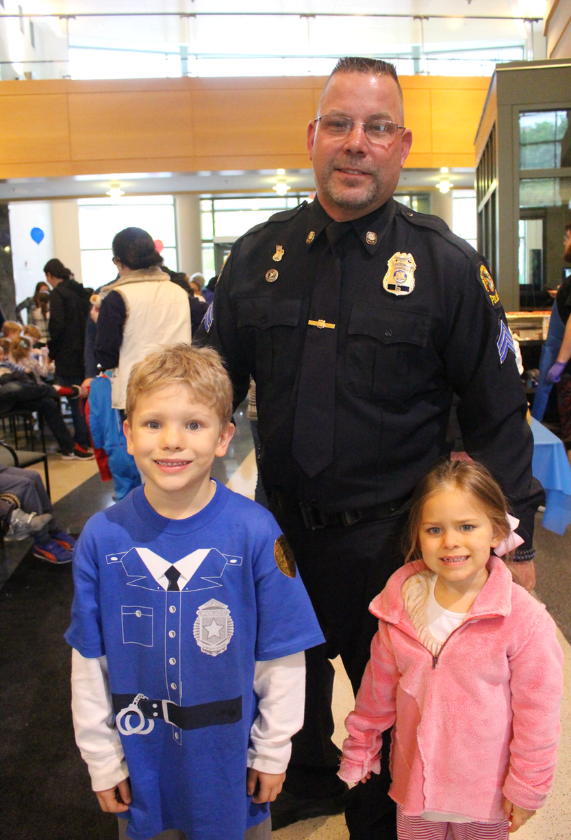 Mrs. Cappiali's children Katie, 3, and Paul Anthony, 7 with Sergeant Thorme at Police Day