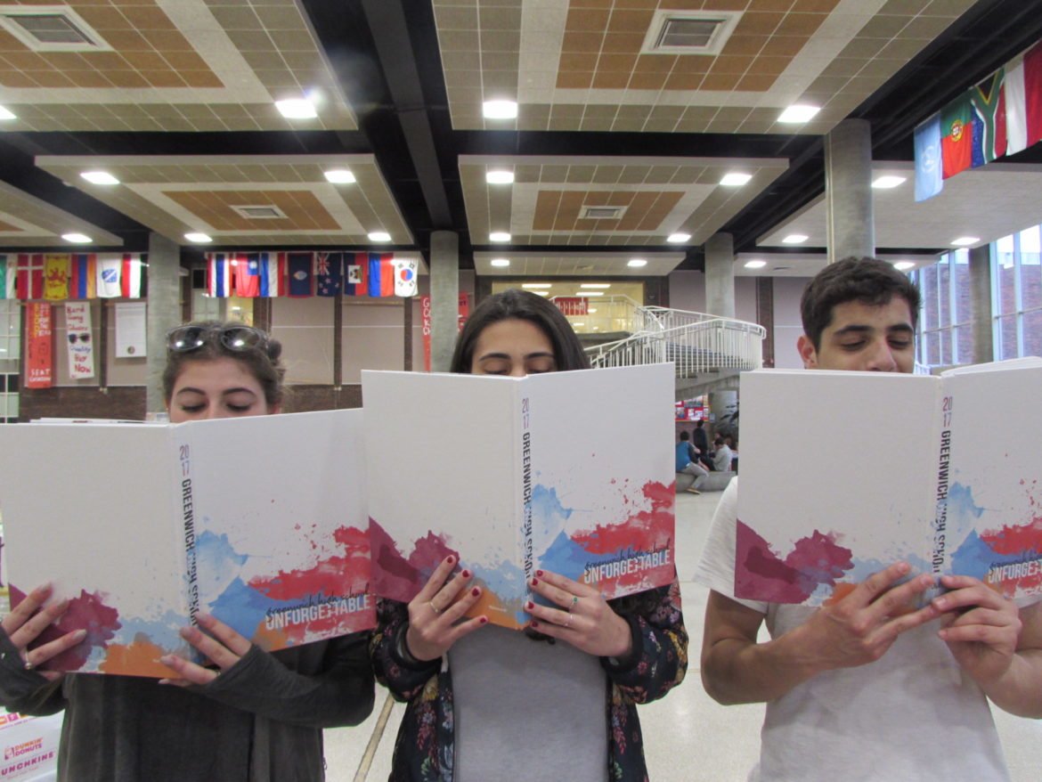 HS seniors pose with their yearbooks at compass night. Photo: Lauren Madigan-Sinclair
