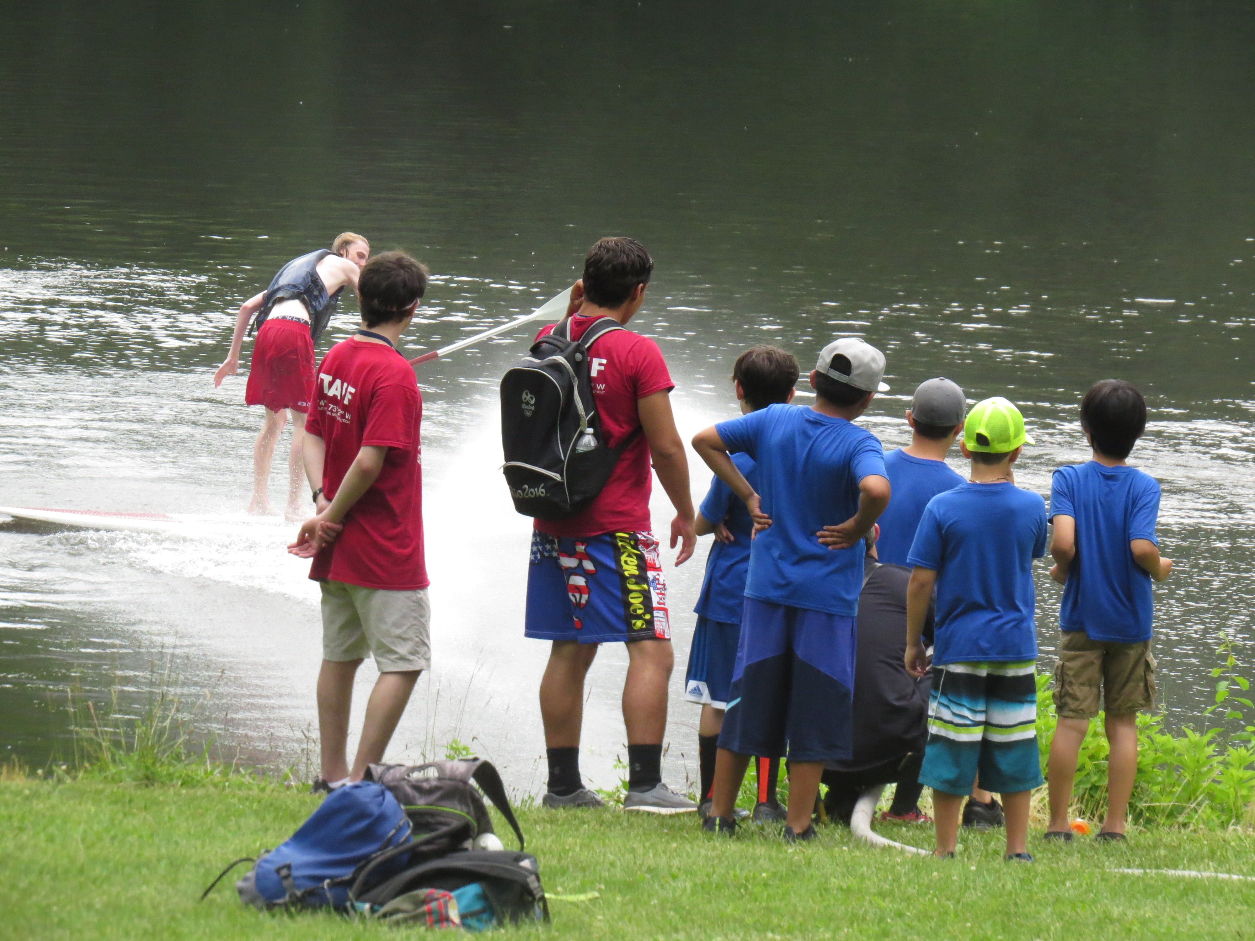 Cub scouts watch staff members get sprayed with water in the lake. June 30, 2017. Photo: Devon Bedoya