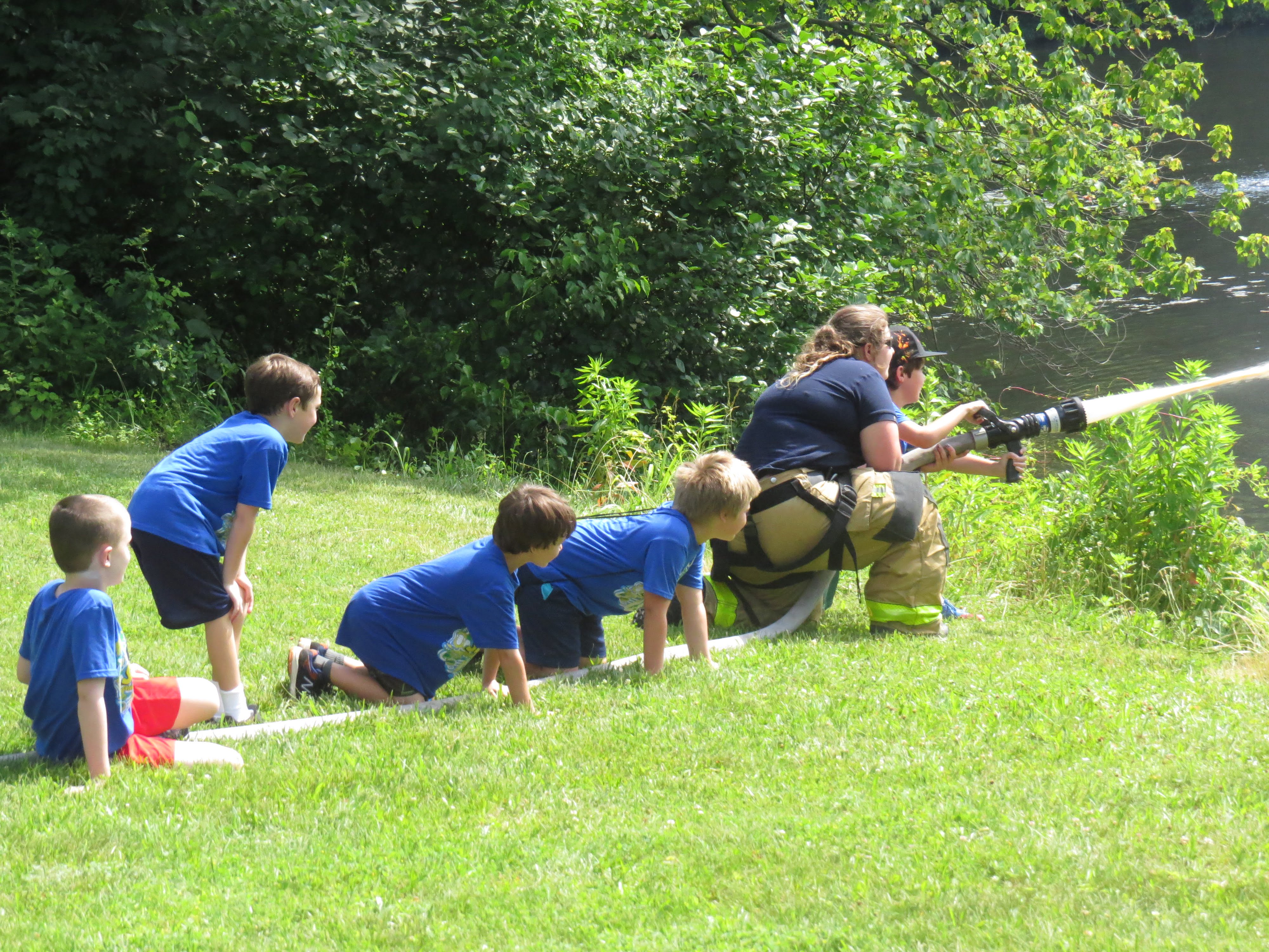 Cub scouts practice spraying a fire hose. June 30, 2017. Photo: Devon Bedoya
