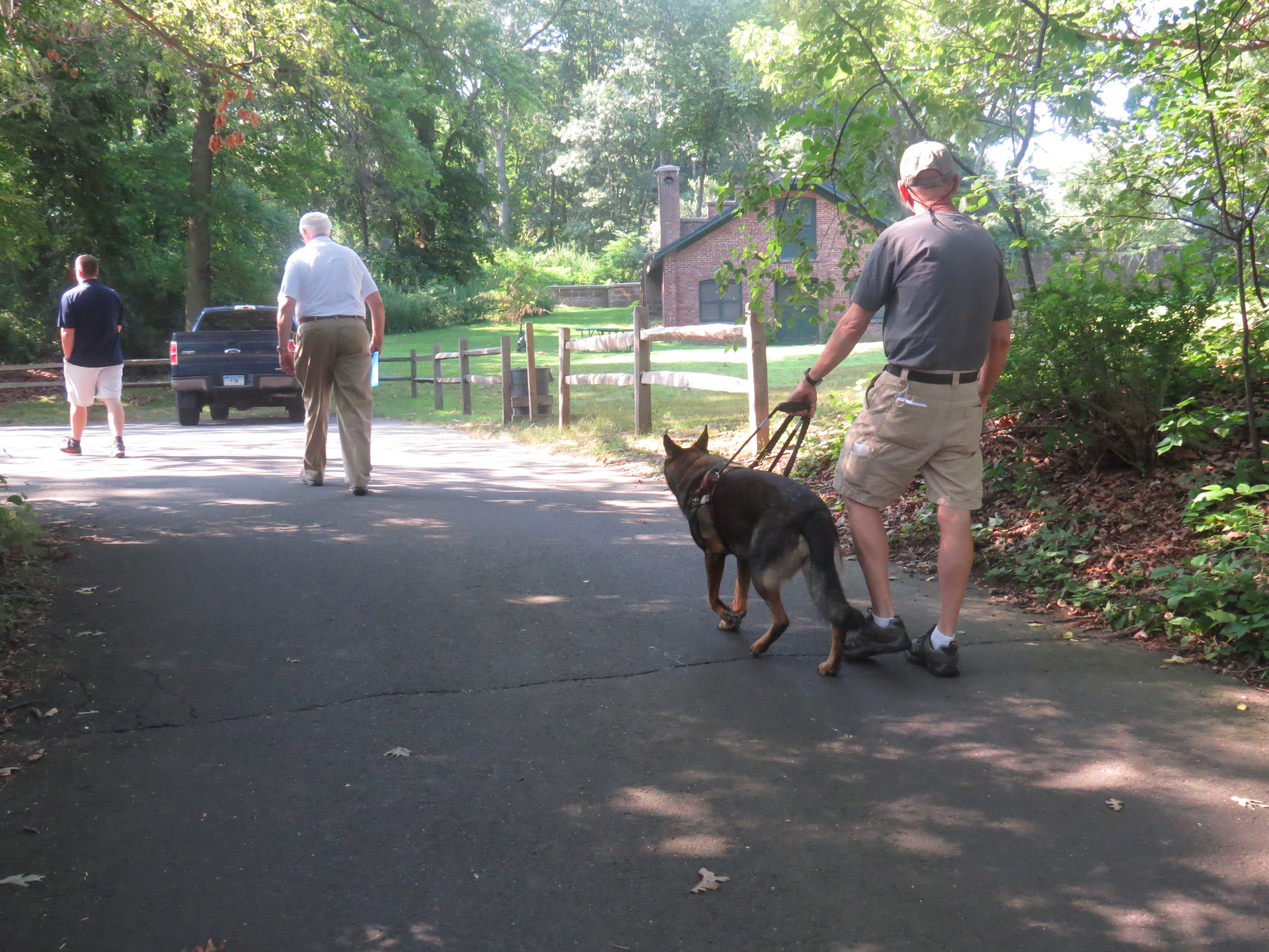 Alan Gunzburg walks with his seeing eye dog, Kili, to the site of the proposed bathroom. July 19, 2017. Photo: Devon Bedoya