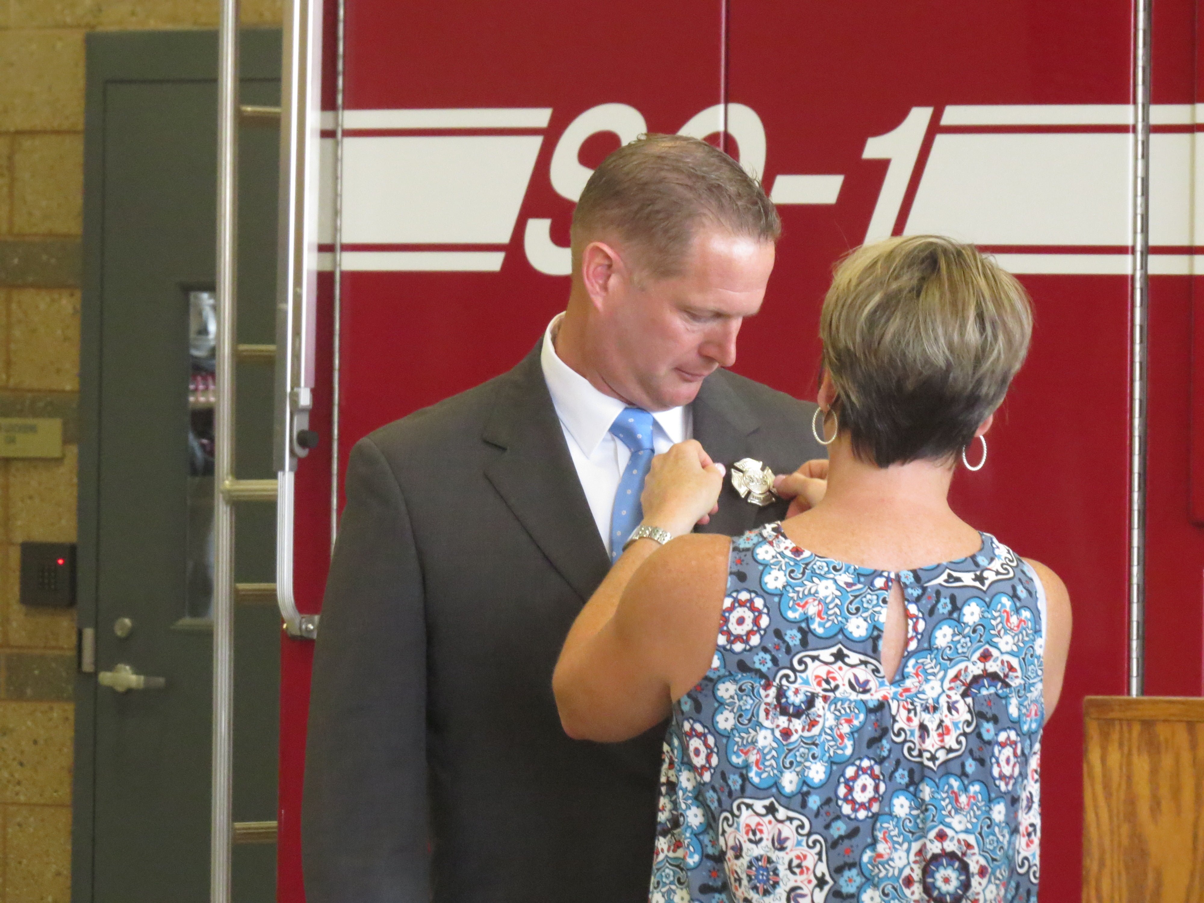 Stephen Brennan gets his badge pinned on after he is sworn in. July 28, 2017. Photo: Devon Bedoya