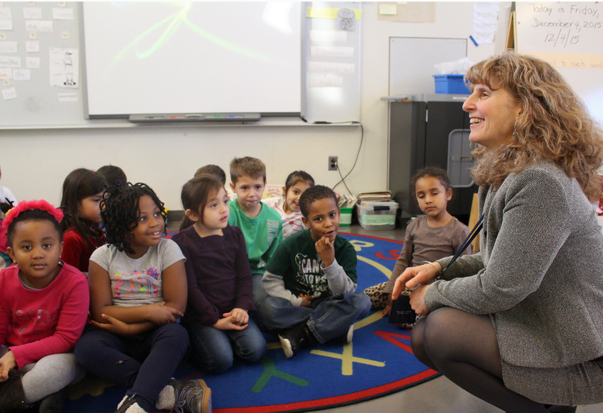Principal Cindy Rigling with kindergartners in Mrs. Sprigg’s class, Dec. 4, 2015. Credit: Leslie Yager