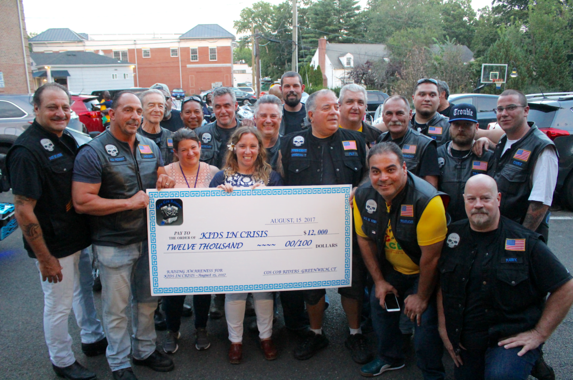 The Cos Cob Riders pose with their jumbo $12,000 check they donated to Kids in Crisis on August 16, 2017 Photo: Leslie Yager