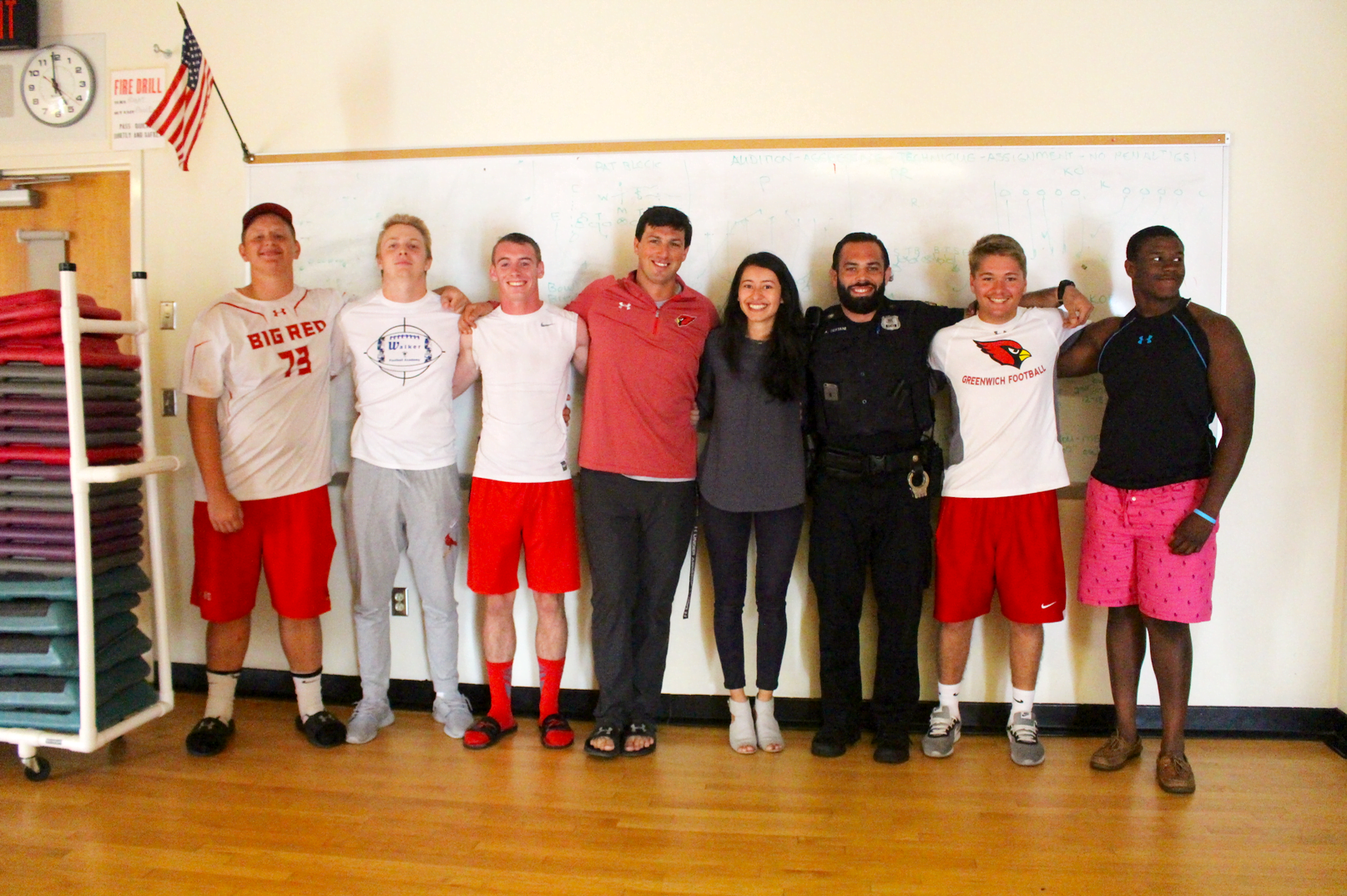 GHS football head coach John Marinelli, YWCA's Yajaira Gonzalez, and Greenwich Police Dept officer Alex Testani with the Greenwich High School football team captains. Aug 17, 2017 Photo: Leslie Yager