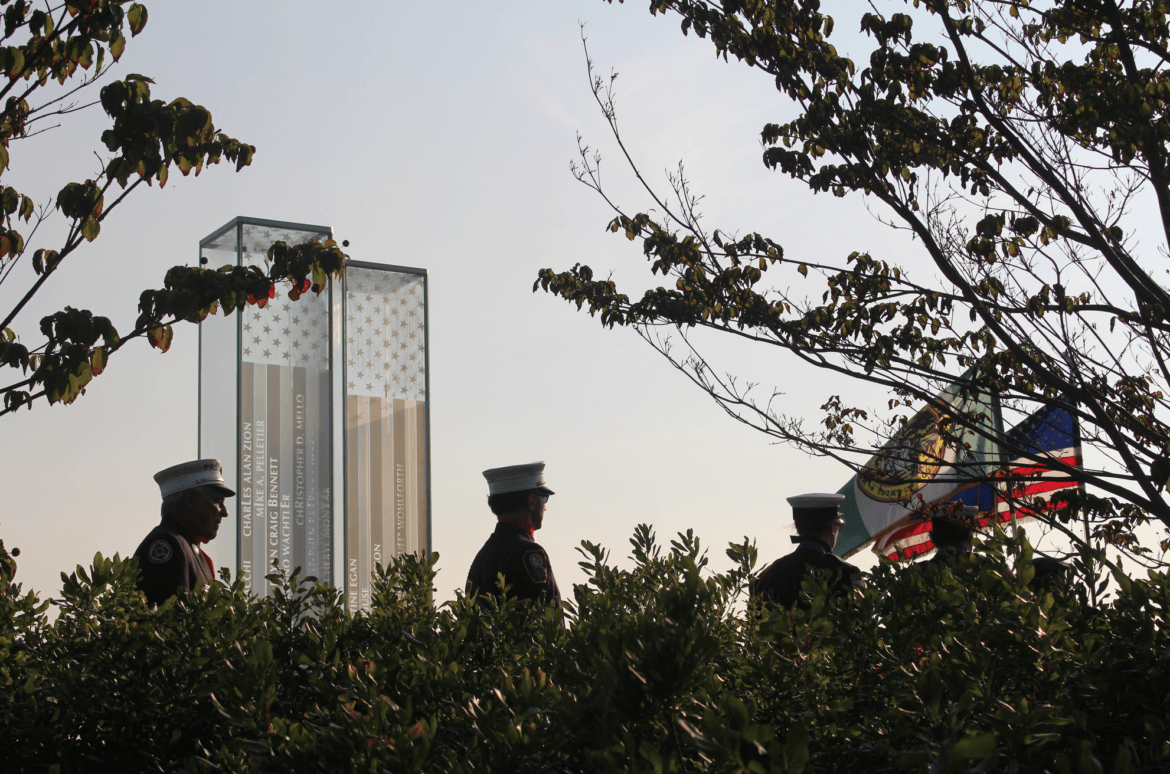 Silhouettes of members of various honor guards at the September 11 memorial in Cos Cob Park. Sept 11, 2017 Photo: Leslie Yager