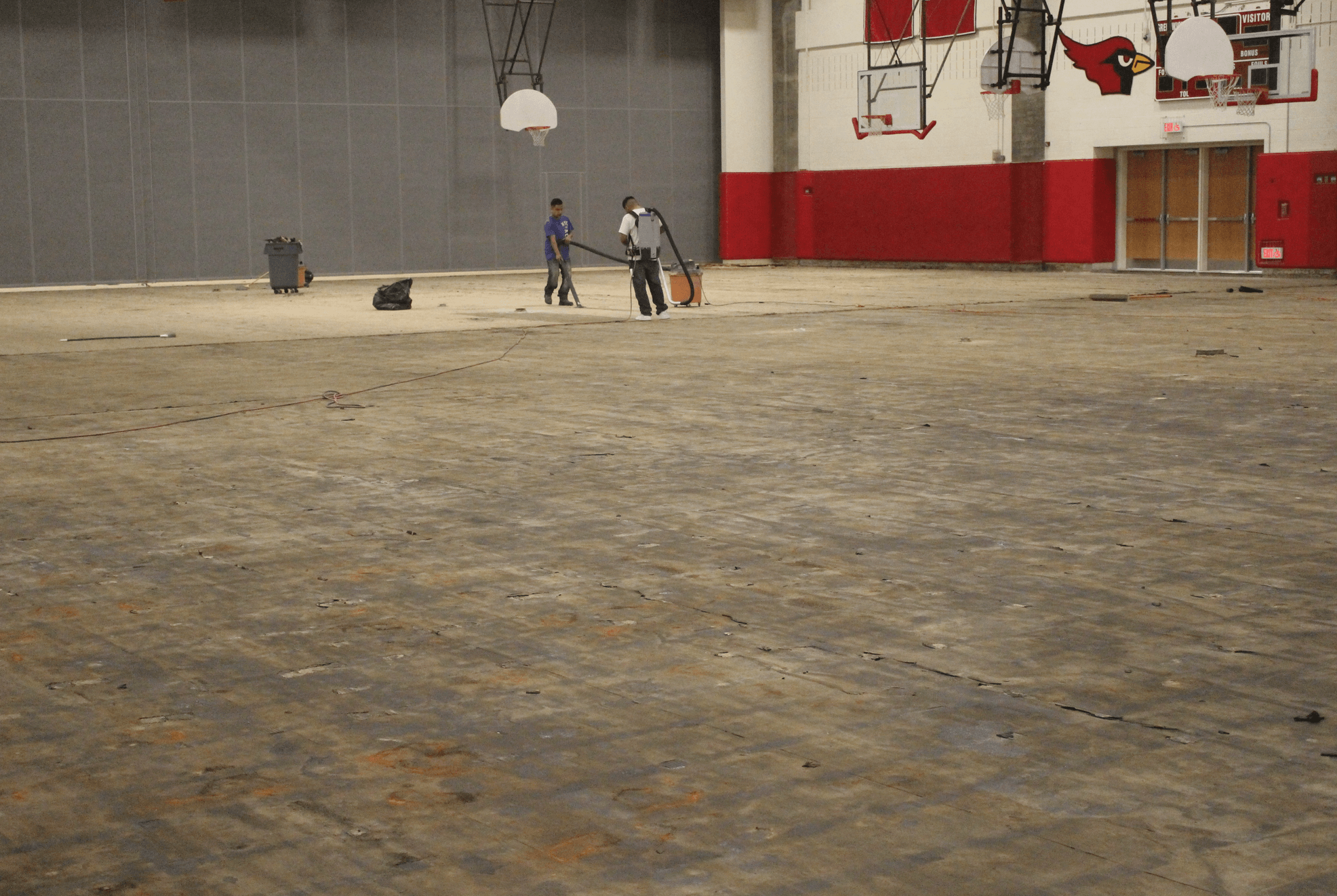 Employees of Dalene Flooring work on the gymnasium floor at GHS the second week of school. Sept 2017 Photo: Leslie Yager