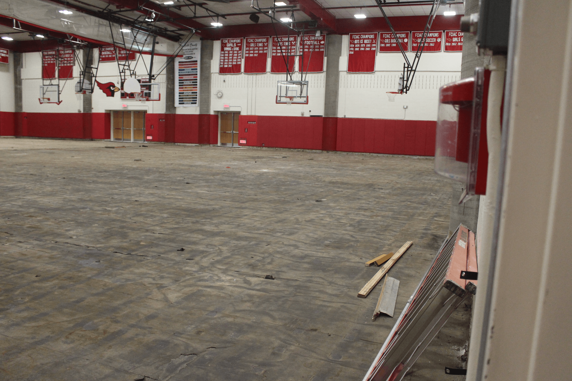 The raw gymnasium floor where bleachers paid for by the GAF will be installed about two weeks after the new gym floor is in place. Photo: Leslie Yager