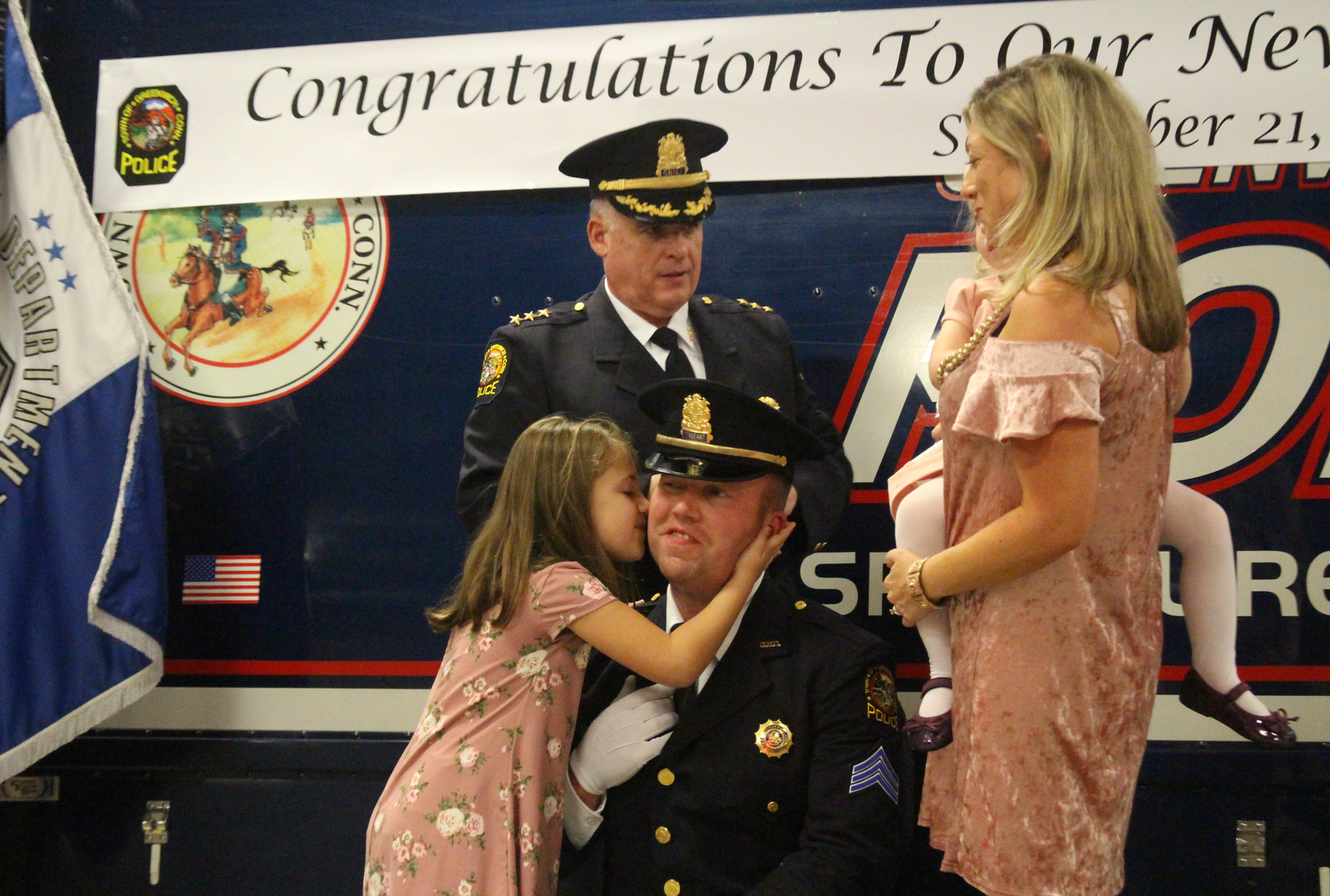Newly promoted Lieutenant Eric Scorca gets a kiss from his proud daughter. Sept 21, 2017 Photo: Leslie Yager