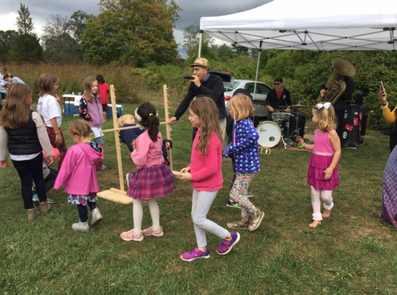  Children do the limbo ska style to the tunes of The Trummytones at the Indian Summer Children’s Festival at Greenwich Audubon.