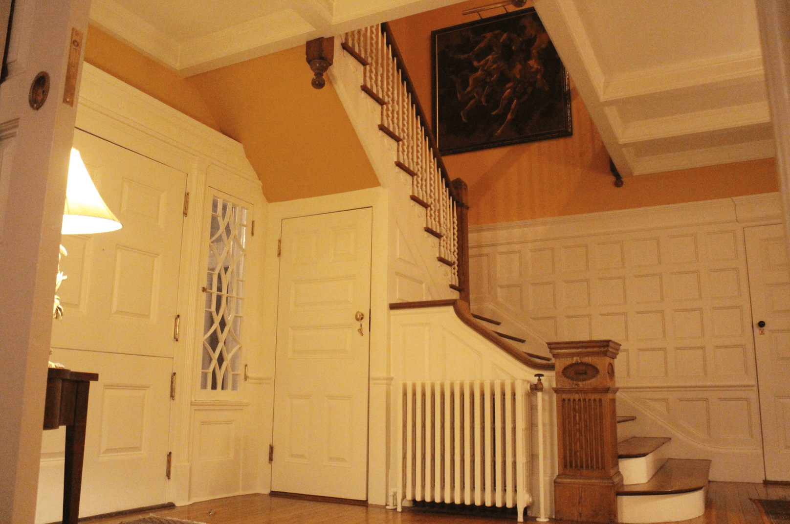 The entrance hall features raised paneling, a wide staircase, large newel post and corkscrew balusters. Most of the interior trim remains and is executed in flamboyant federal style, most notable in the fireplace mantles. Photo: Leslie Yager