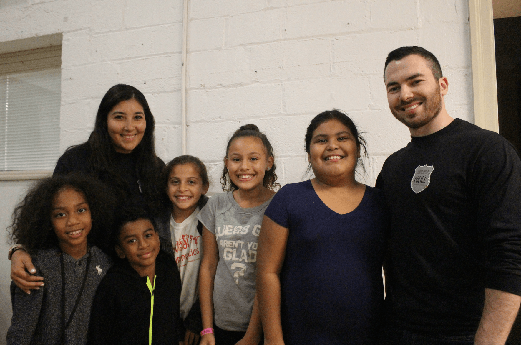 Officer Ericka Garcia with friends at the Boys & Girls Club Thanksgiving feast, Nov. 21, 2017 Photo: Leslie Yager