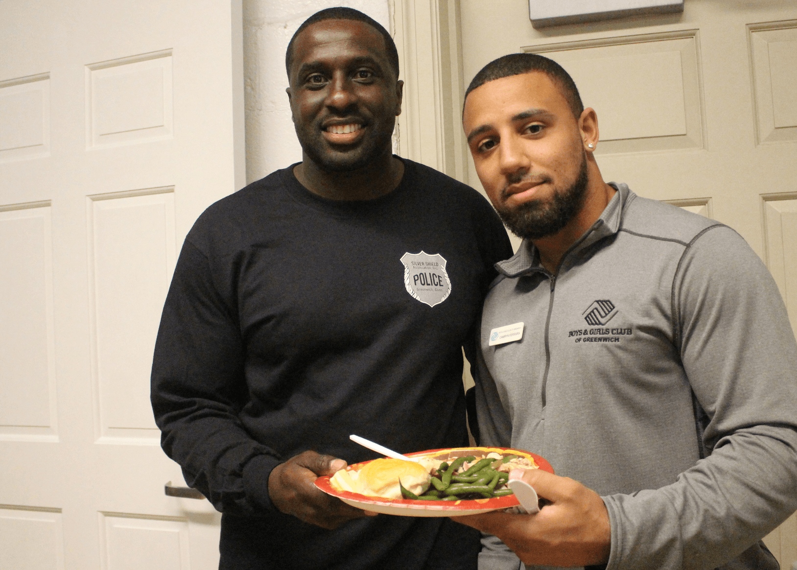 Officer Michael Hall and Boys & Girls Club athletic coordinator Camryn Ferrara at the Thanksgiving feast, Nov. 21, 2017 Photo: Leslie Yager
