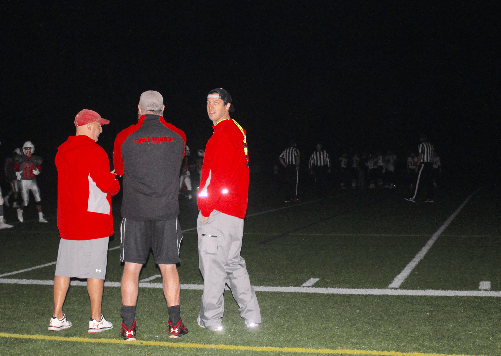 Coaches on the sidelines at the end of the JV football game on field 7 in the semi-dark. Nov 6, 2017 Photo: Leslie Yager