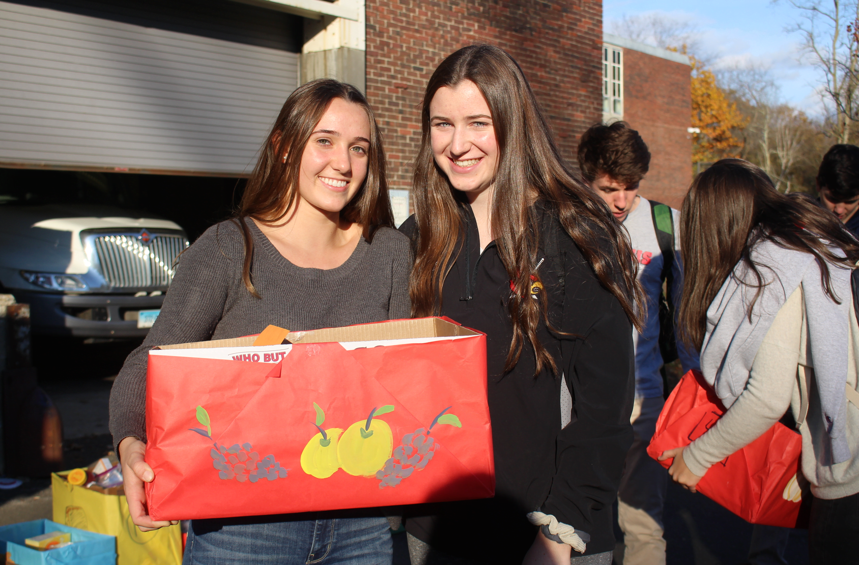 Carolina Lew (11th) and Hannah Doyle (12) carry boxes to the south loading dock at GHS for the Roots & Shoots Thanksgiving meal project. Nov 20, 2017 Photo: Leslie Yager