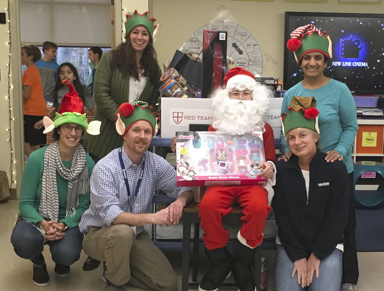 Upper School teachers and Santa collect toys at The Elf Toy Drive. Front row, from left: Lindsay Sudeikis, Phil Lohmeyer, Santa (6th grader George Markov), Annette Iverson. Back row, from left: Alicia Miller, Padma Iyler. contributed photo