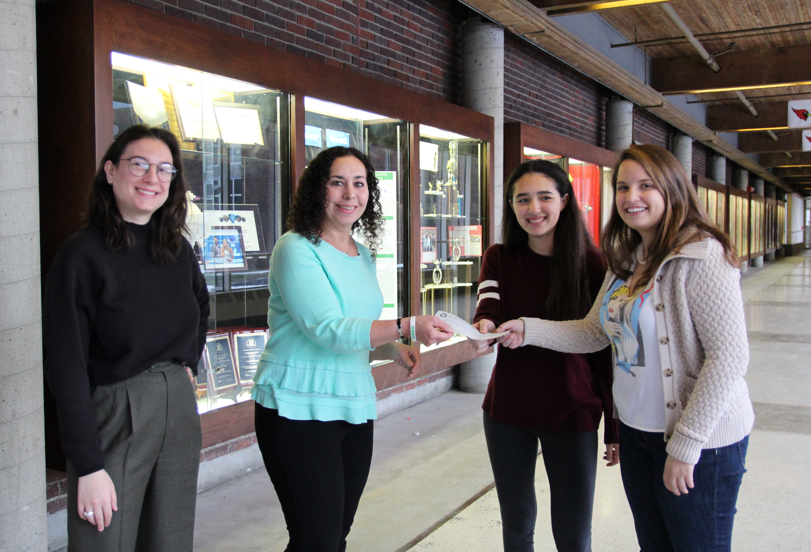  Fairco Greentree Recycling's Rebecca Lehner and The Harris Project founder Stephanie Marquesano receive a check from GHS Outreach Club's Rosanna Neri. Jan 10, 2018 Photo: Leslie Yager