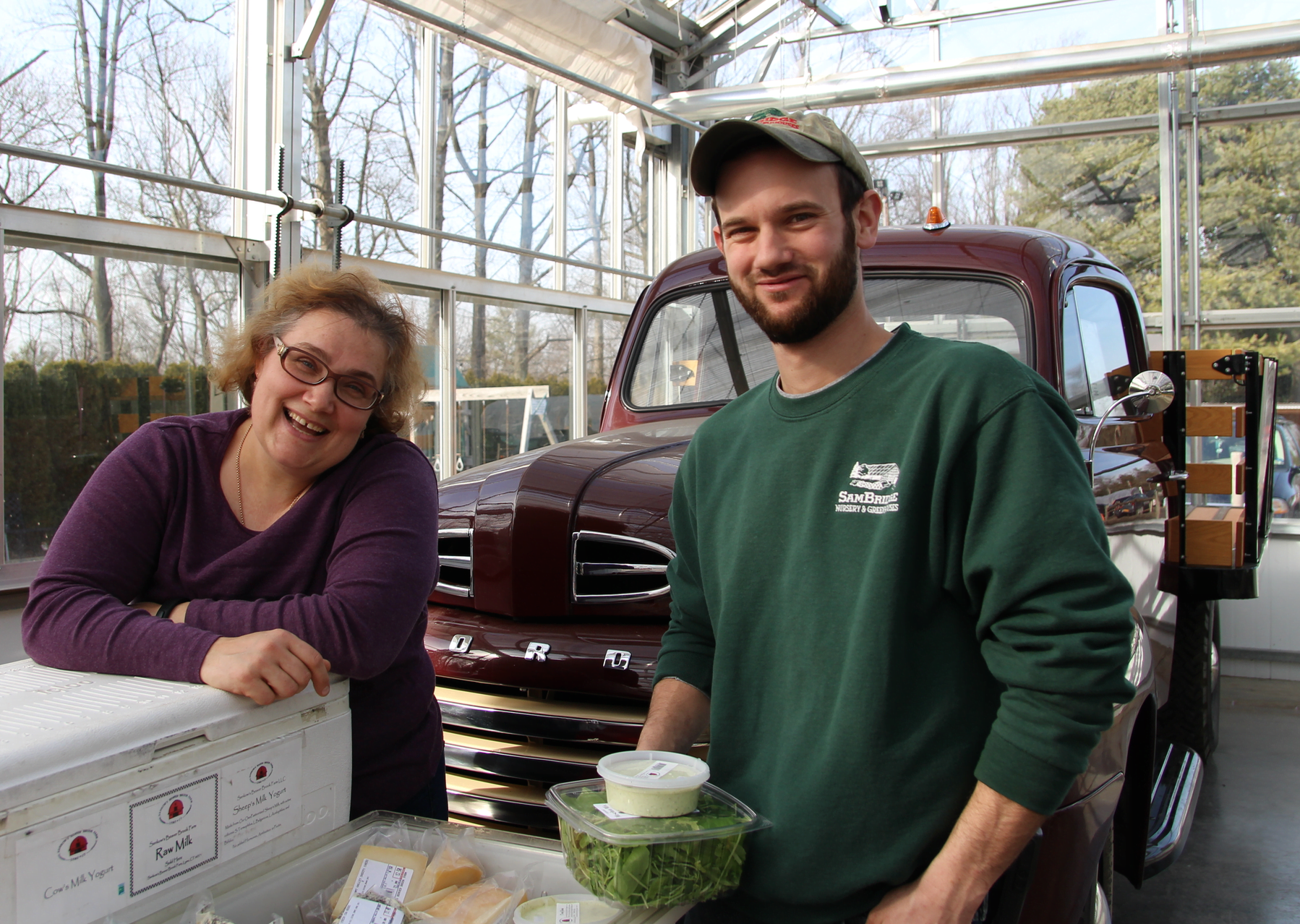 Victoria from Sankow's Beaver Brook Farm with Nick Bridge, manager of the winter farmers market. Photo: Leslie Yager