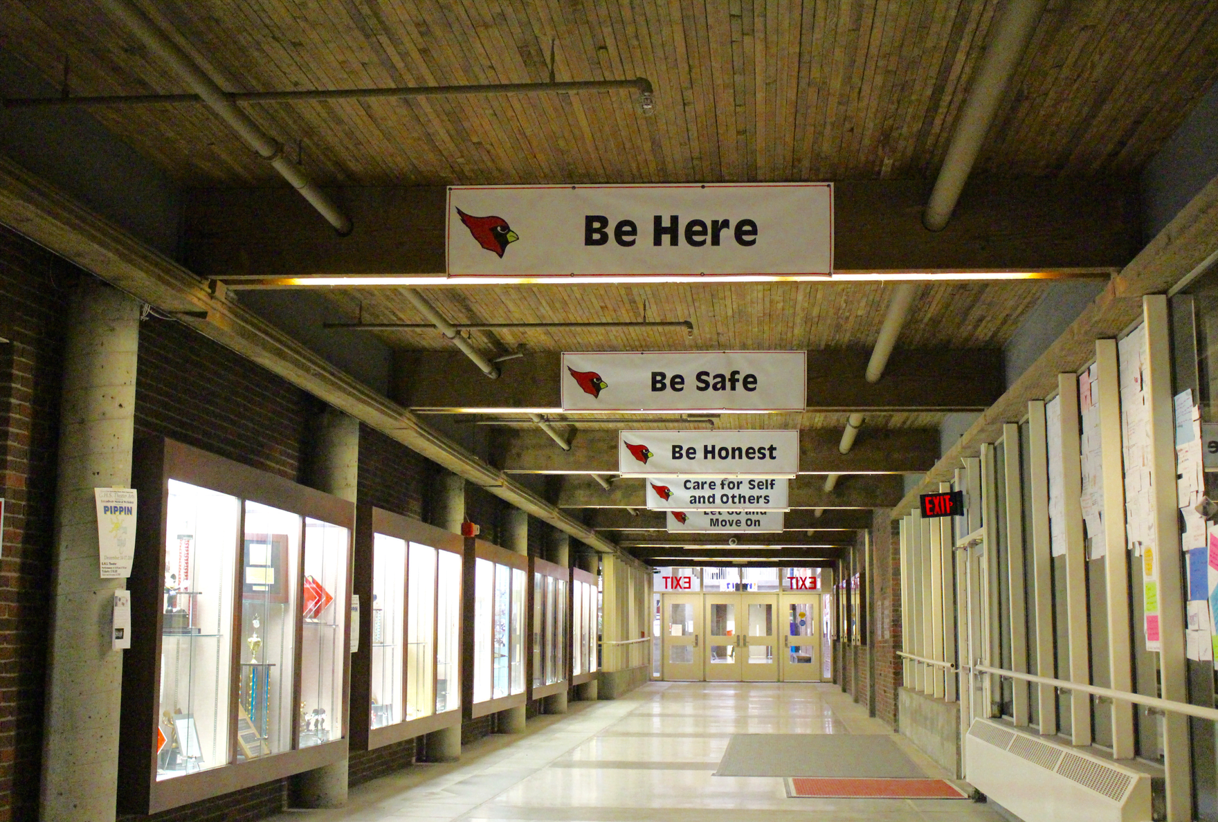 District norms posted overhead along the glass corridor at the entrance of Greenwich High School. 
