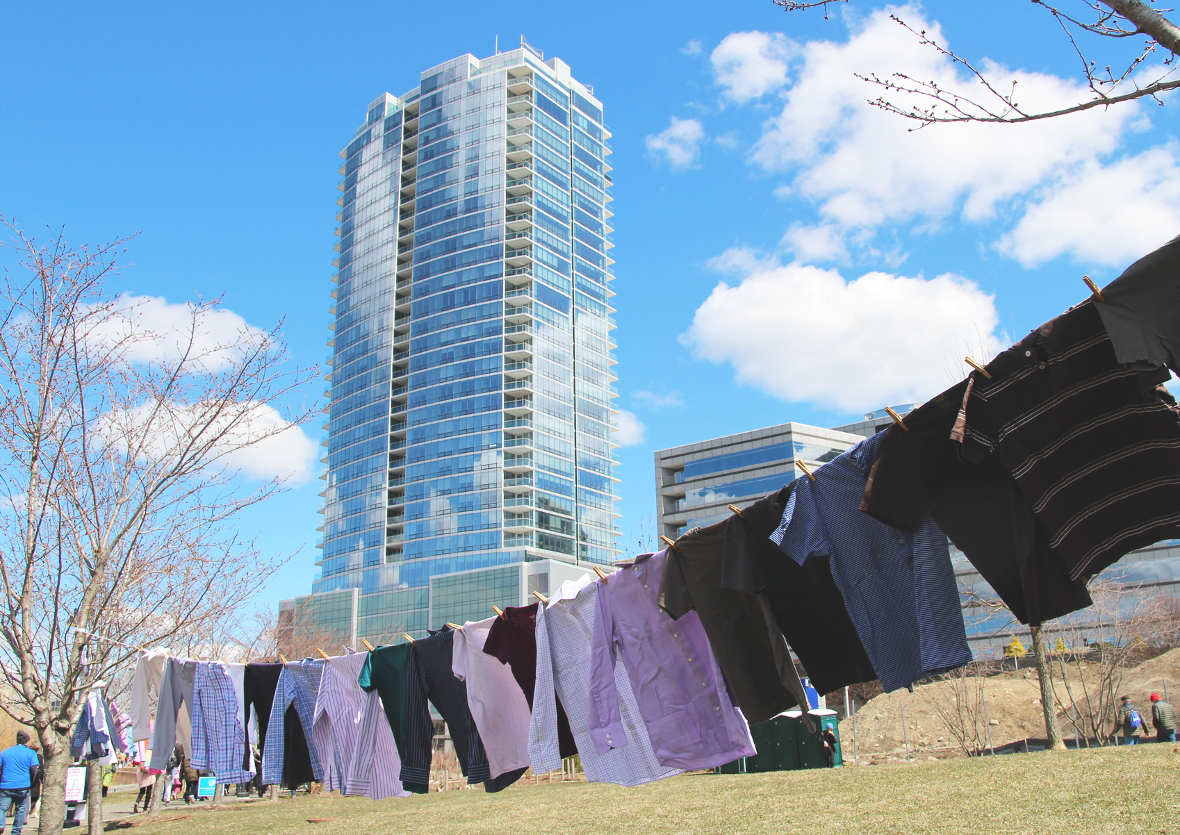 96 shirts were strung on clothes line on the periphery of Mill River Park, with Trump Parc Stamford in the background. March 24, 2018 Photo: Leslie Yager