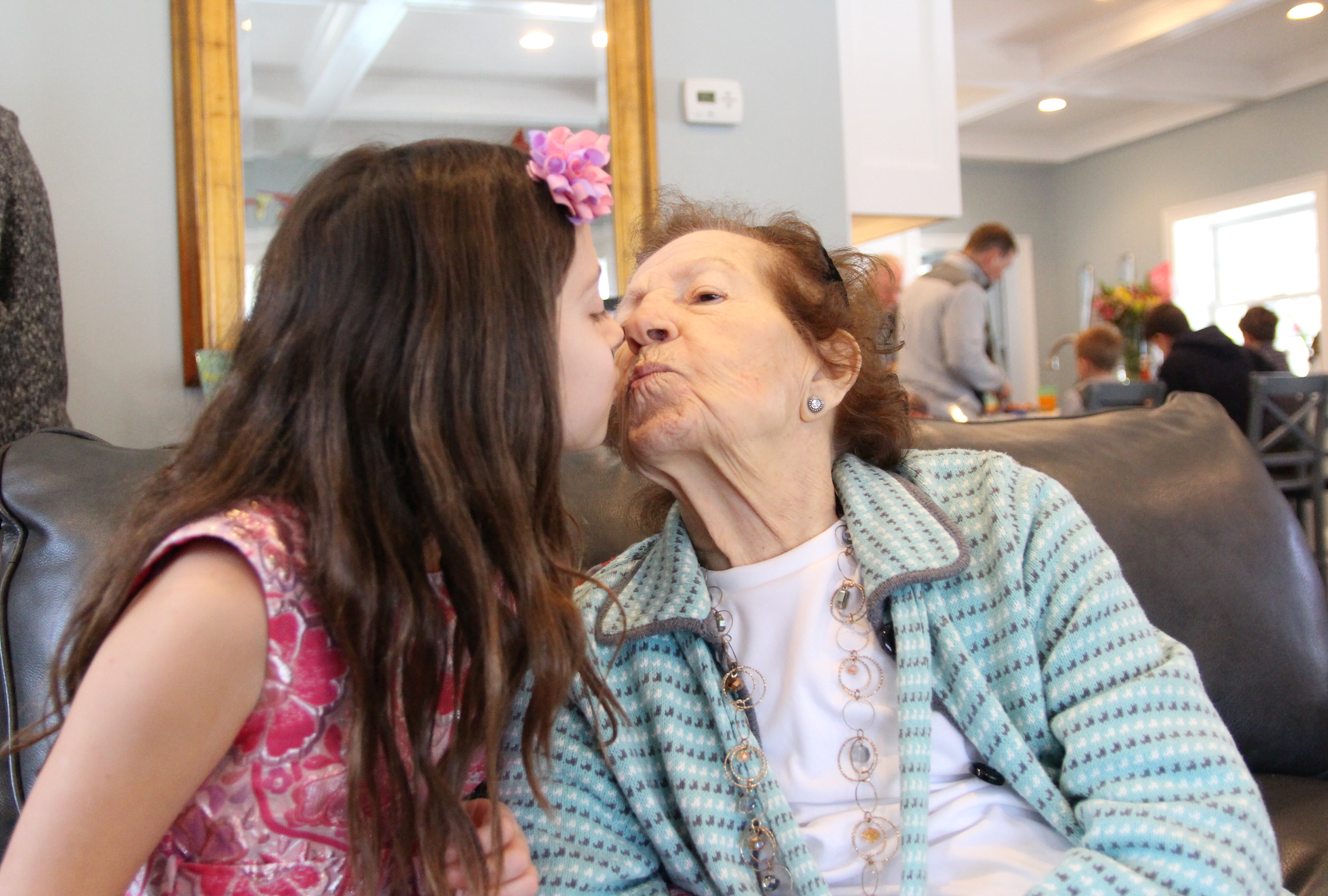Piper Reynolds gives her great grandmother Marion a kiss onher birthday. March 11, 2018 Photo: Leslie Yager