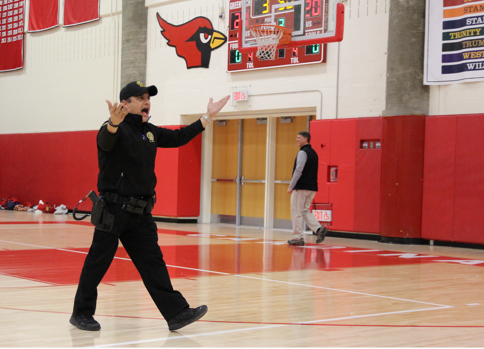 Officer Carlos Franco got the Cardinal Crazies to cheer at a basketball game in February. Photo: Leslie Yager